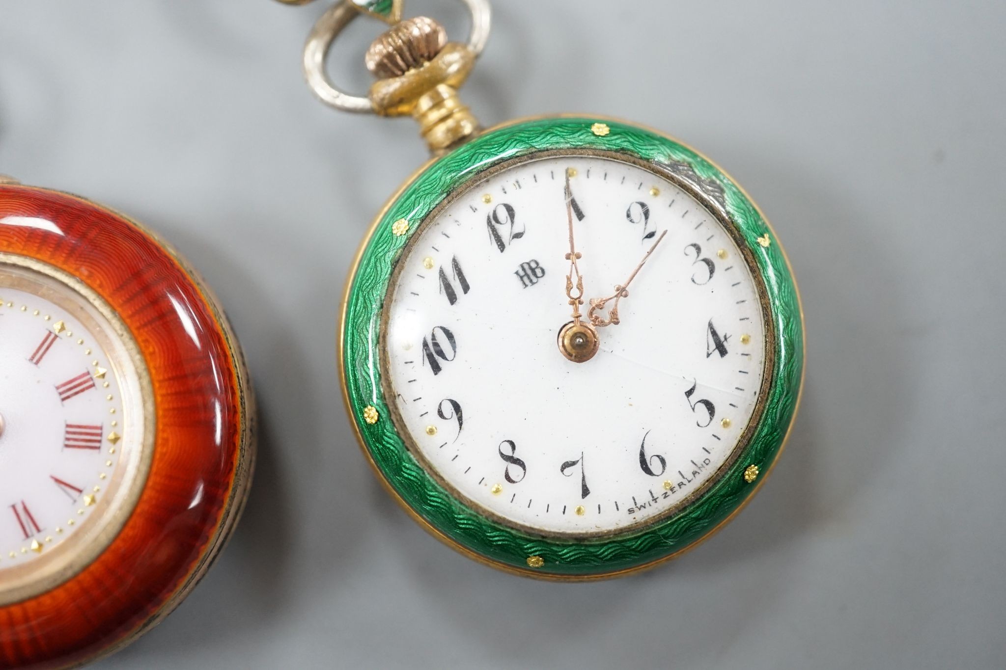 Two lady's early 20th century gilt metal and enamelled fob watches, on enamelled suspension brooches.